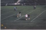 Spencer walking on the field with the coach