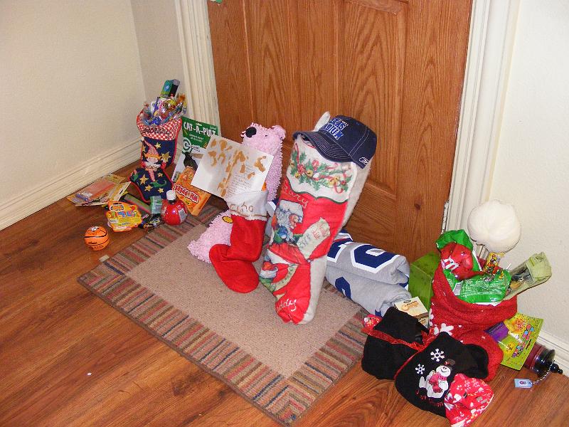 DSCF3898.JPG - All the stockings, Santa leaves them by the door rather than try to navigate down our fireplace